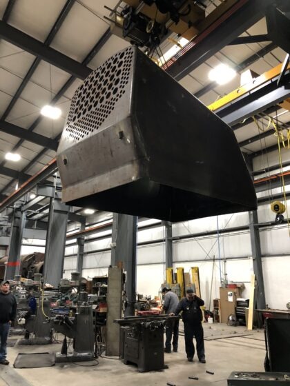 The completed firebox is being moved to the front of the shop for shipment to the customer.